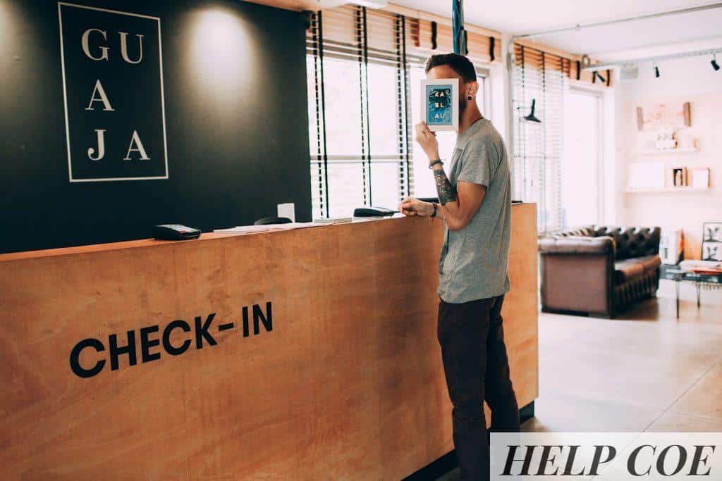 man standing beside counter