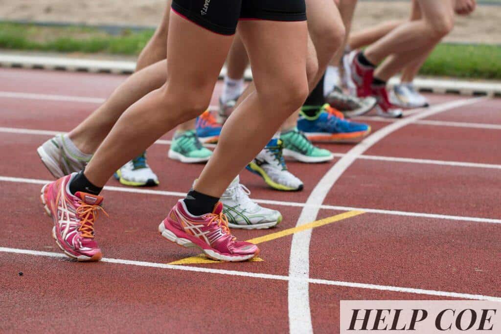 Close-up of athletes' feet at the starting line, prepared for a track race.
