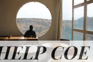 man sitting on chair near window